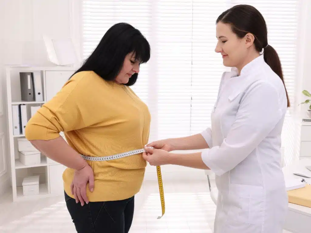 Doctor's measuring the patients waist