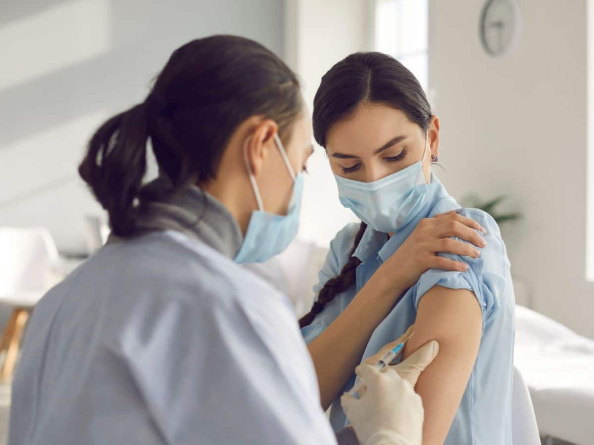 young woman getting antiviral vaccine