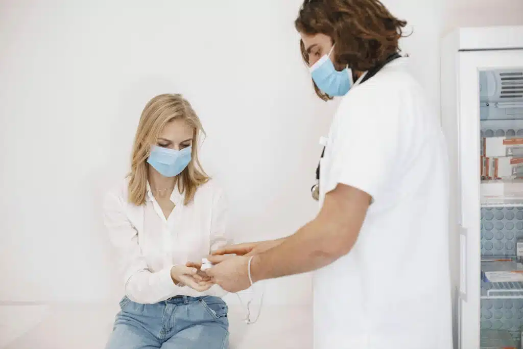 A Woman Wearing a Face Mask Getting a Checkup