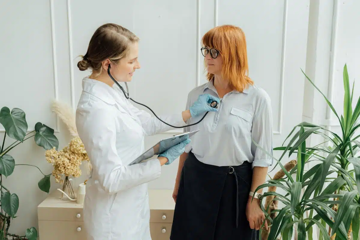 Doctor doing a heath health to the woman