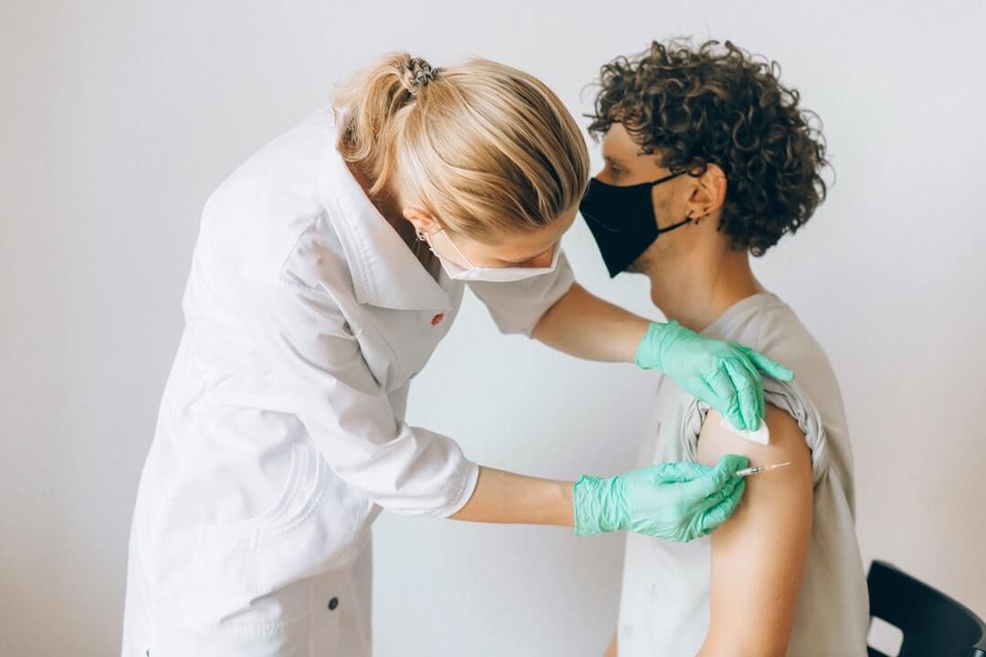 adult man having a vaccine