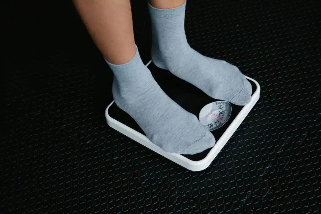 Female checking her weight using a weight scale